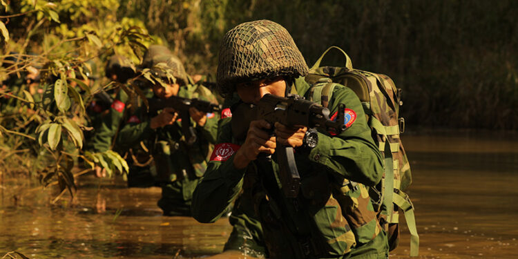 An Arakan Army soldier patrols in northern Rakhine State. / Arakan Army