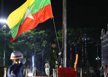 A guard of honor raises the Myanmar National Flag during a ceremony in Yangon on Thursday commemorating the 70th anniversary of independence from British rule. / Myo Min Soe / The Irrawaddy