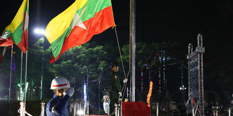 A guard of honor raises the Myanmar National Flag during a ceremony in Yangon on Thursday commemorating the 70th anniversary of independence from British rule. / Myo Min Soe / The Irrawaddy