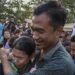 A prisoner released under the presidential amnesty is greeted by a family member in front of Insein Prison on Wednesday. / Htet Wai / The Irrawaddy