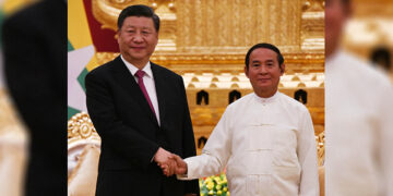 Myanmar President U Win Myint (right) and Chinese President Xi Jinping (left) pose for a photo after the bilateral meeting in January. / Myanmar President Office