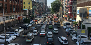 Parked vehicles flank a congested street in central Yangon. / Zaw Zaw Htwe