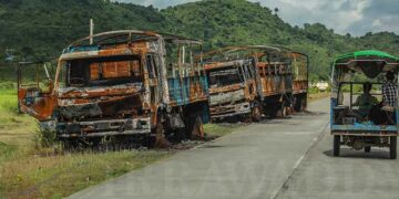 Burned trucks lie abandoned next to the Yangon-Sittwe Highway near Yoe Ta Yoke Village in Ponnagyun Township, Rakhine State, in September 2019. / Zaw Zaw / The Irrawaddy