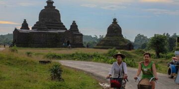 Residents bike around an ancient monument in the tourist town of Mrauk-U, Rakhine State in September 2019. / Zaw Zaw / The Irrawaddy