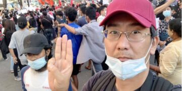 Yuki Kitazumi raises a three-finger salute, a symbol of Myanmar's anti-coup movement, in this undated photo. / Yuki Kitazumi's Facebook page / Kyodo