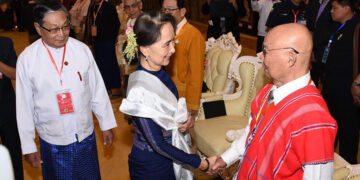 Myanmar State Counselor Daw Aung San Suu Kyi greets chairman of the KNU Saw Mutu Say Poe during a special meeting between the Union government and signatories of the Nationwide Ceasefire Agreement in Naypyitaw on Oct. 15. / State Counselor’s Office