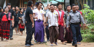 The six activists walk in front of the Loikaw Township Court on August 26, 2019. / Athan