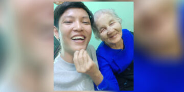 Kyaw Zin Win smiles with his grandmother, Daw Saw Nan, who he lived with his entire life. / Facebook user White Magic
