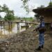 A Myanmar border guard police officer stands guard in Taung Bazar village, Buthidaung Township, northern Rakhine State, on July 13, 2017. / Reuters