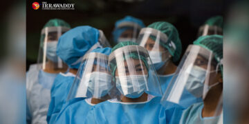 Health workers on their way to carry out house-to-house screenings to check residents for symptoms of COVID-19 in Yangon in May 2020. / Aung Kyaw Htet / The Irrawaddy