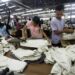 Workers iron and arrange clothing at a garment factory at Hlaing Taryar Industrial Zone in Rangoon, March 10, 2010. / Reuters