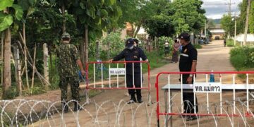 Guards at the entrance of a factory in Mae Sot under lockdown.