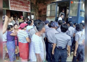 Farmers are taken back to prison after the trial. / The Irrawaddy