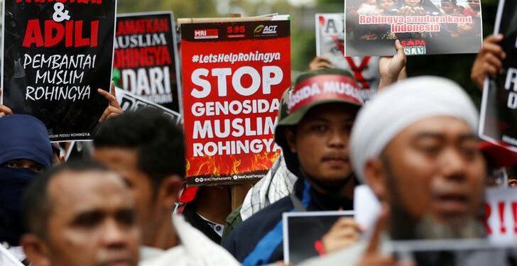 Protesters hold signs during a demonstration against what organizers say is the crackdown on ethnic Rohingya Muslims in Burma, outside the Burmese embassy in Jakarta, Indonesia on November 25, 2016. The text on the poster reads, “Rohingya are our brothers.” / Darren Whiteside / Reuters