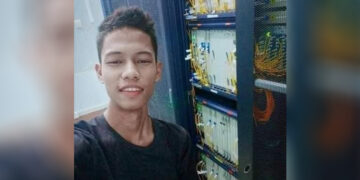 Fellow protesters carry Nyi Nyi Aung Htet Naing. He was shot dead outside No. 5 Basic Education High School in Kamayut Township.