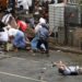 Kenji Nagai of APF tries to take photographs as he lies injured after police and military officials fired upon and then charged at protesters in Yangon on Sept. 27, 2007. Nagai, 50, a Japanese video journalist, was shot by soldiers as they fired to disperse the crowd. Nagai later died. / Reuters