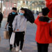 People wearing protective masks walk in a shopping district, following an outbreak of the coronavirus disease (COVID-19) in Beijing, China on March 25, 2020. / REUTERS