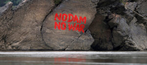 Graffiti is seen on a stone at the confluence of the Mali and Nmai rivers—the source of the Irrawaddy River—at Myitsone outside Myitkyina, Kachin State in March 2017. / Reuters