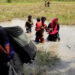 Rohingya people wade through water as they try to reach the Bangladesh side of the border from No Man’s Land after hearing a gunshot from the Myanmar side, in Cox’s Bazar, Bangladesh on Aug. 28, 2017. / Reuters