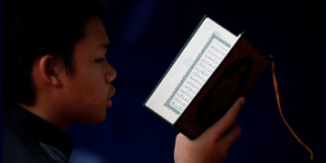 A boy reads the Koran during the holy fasting month of Ramadan at a mosque in Jakarta, Indonesia, June 3, 2019 / Reuters