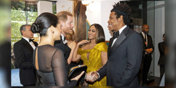 Britain's Prince Harry, Duke of Sussex, and Meghan, Duchess of Sussex, greet Beyonce and her husband Jay-Z at the European premiere of the film 'The Lion King' in London. / Reuters
