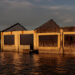 A dilapidated school sits next to a partly submerged church in the coastal village of Sitio Pariahan, the Philippines, on Nov. 27, 2019. Rising sea levels caused by global warming could soon make this village unlivable, a problem faced by other countries in Asia, where the poorest communities are worst hit. / REUTERS