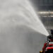 Firefighters spray disinfectant using a high-pressure pump truck to prevent the spread of COVID-19 on a road in Jakarta, Indonesia, on March 31, 2020. / Reuters