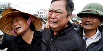 Relatives of John Nguyen Van Hung, who was found dead in the back of a truck in Britain last month, cry while following an ambulance carrying his body in Nghe An province, Vietnam on Nov. 27, 2019. / Reuters