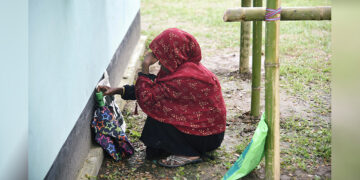 A woman waits to check her name on the draft list of the National Register of Citizens outside a registration center in Rupohi village in India’s Assam state on Aug. 31, 2019. / REUTERS