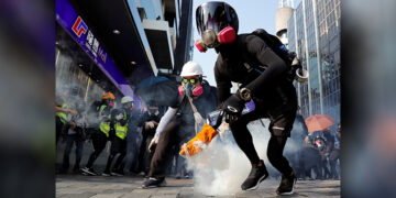 An anti-government demonstrator holds a tear gas canister during a protest march in Hong Kong, China on Oct. 20, 2019. / REUTERS