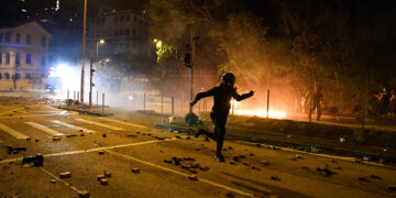 An anti-government protester runs during clashes with police at Hong Kong Polytechnic University in Hong Kong, China November 17, 2019. / Reuters