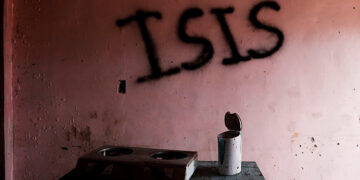 Burnt kitchen items are seen in front of a wall spray-painted with the word ‘ISIS’ in a home in Marawi City, Philippines, on May 11, 2019. The city remains abandoned two years after pro-Islamic State militants began their attacks on it in May 2017. / Reuters