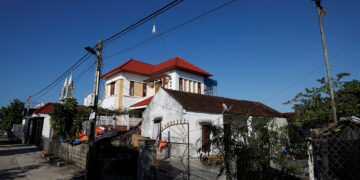The newly-built house (right) of Bui Chung, who worked in Britain as an illegal laborer, is seen next to an older house in Do Thanh commune, in Nghe An province, Vietnam on Oct. 29, 2019. / Reuters