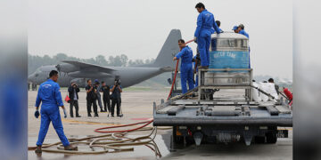 Members of the Malaysian Air Force’s cloud-seeding team prepare to seed clouds over Kuala Lumpur at a military airbase in Subang, Malaysia, on Sept. 19, 2019. / REUTERS