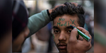 A demonstrator has a slogan written on his forehead as he attends a protest against a new citizenship law outside Jamia Millia Islamia university in New Delhi on Dec. 22, 2019. / REUTERS