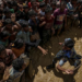 A security officer attempts to control Rohingya refugees waiting to receive aid in Cox's Bazar, Bangladesh, September 21, 2017. / Reuters