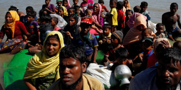 Rohingya refugees sit on a makeshift boat as they get interrogated by the Border Guard Bangladesh after crossing the Bangladesh-Myanmar border, at Shah Porir Dwip near Cox's Bazar, Bangladesh November 9, 2017. (Navesh Chitrakar/Reuters)