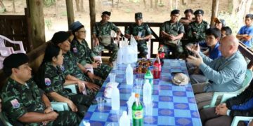 Dr. Kevin LaChapelle talks to KNLA officials at a KNLA base in Karen State.