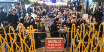 People sit outside bars and restaurants in Soho, London during Halloween celebrations on Saturday. / Getty / Kyodo