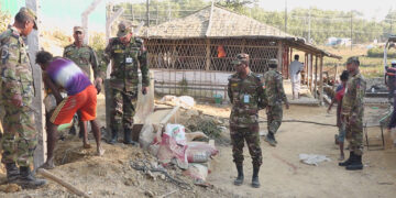 Bangladeshi soldiers oversee the installation of pillars for a barbwire fence near a Rohingya refugee camp in Ukhia, Cox’s Bazar, Bangladesh in December 2019. / Helal Uddin