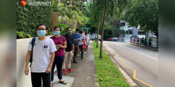 Voters in Singapore wait outside Myanmar’s embassy on Thursday to cast their advance votes for the November general election. / Khin Hnin Swe