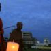 Thai Buddhist monks walk with candles through Bangkok’s Thammasat University on Oct. 6, 2006 / Adrees Latif / Reuters