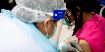 A woman receives a jab as Thai government officials and WHO representatives launch the nationwide COVID-19 vaccination rollout at Bangsue Central Vaccination Center in Thailand on June 7, 2021. / World Health Organization Thailand / Facebook