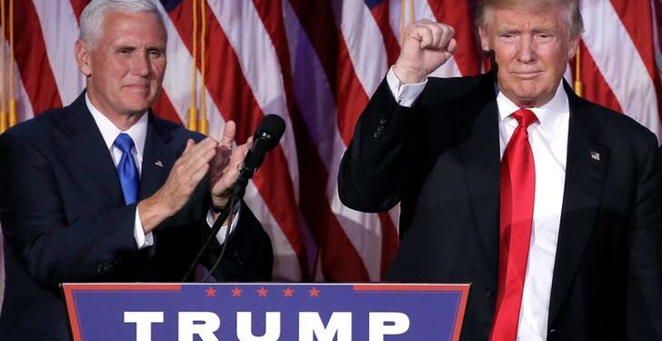 President-elect Donald Trump gestures as Vice President-elect Mike Pence applauds (L) at their election night rally in Manhattan, New York, US. / Mike Segar / Reuters