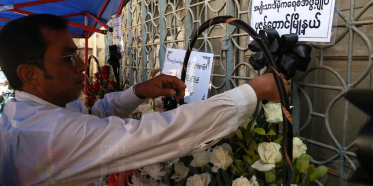 A man pays his respects outside the home of lawyer U Ko Ni who was assassinated on Sunday. / Chan Son / The Irrawaddy
