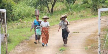 Local farmers leave the mango plantation allegedly owned by former President U Thein Sein. / Htet Naing Zaw / The Irrawaddy