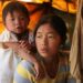 A refugee from Bhamo waits with her daughter at the Jegau camp in KIO-controlled territory near the Chinese border, Feb. 2012. / Seamus Martov