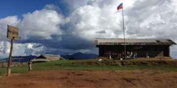 The Wa flag flies outside a school in Northern Wa Region. / Andrew Ong