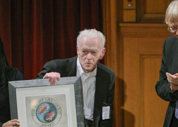 Professor Gene Sharp (center) and associate Jamila Raqib of the Albert Einstein Institution in Boston receive the Right Livelihood Prize from founder Jacob von Uexkull (right) during a ceremony at the Swedish Parliament in Stockholm on Dec. 7, 2012. / Reuters