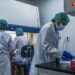 Medical staff conduct COVID-19 tests at the laboratory of the Department of Medical Research on Aug. 21. / Htet Wai / The Irrawaddy